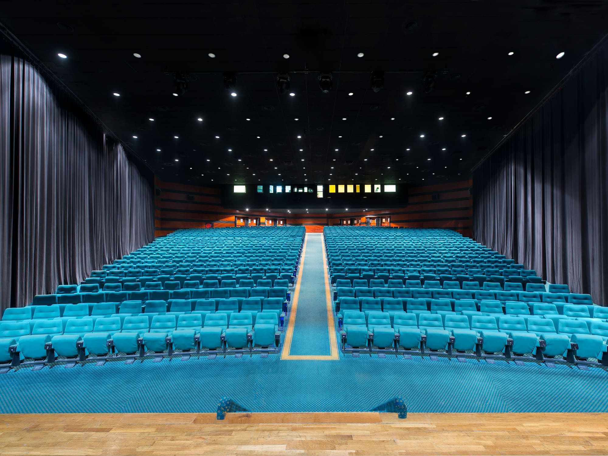 a large auditorium with blue seats