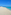 a beach with blue water and a clear sky