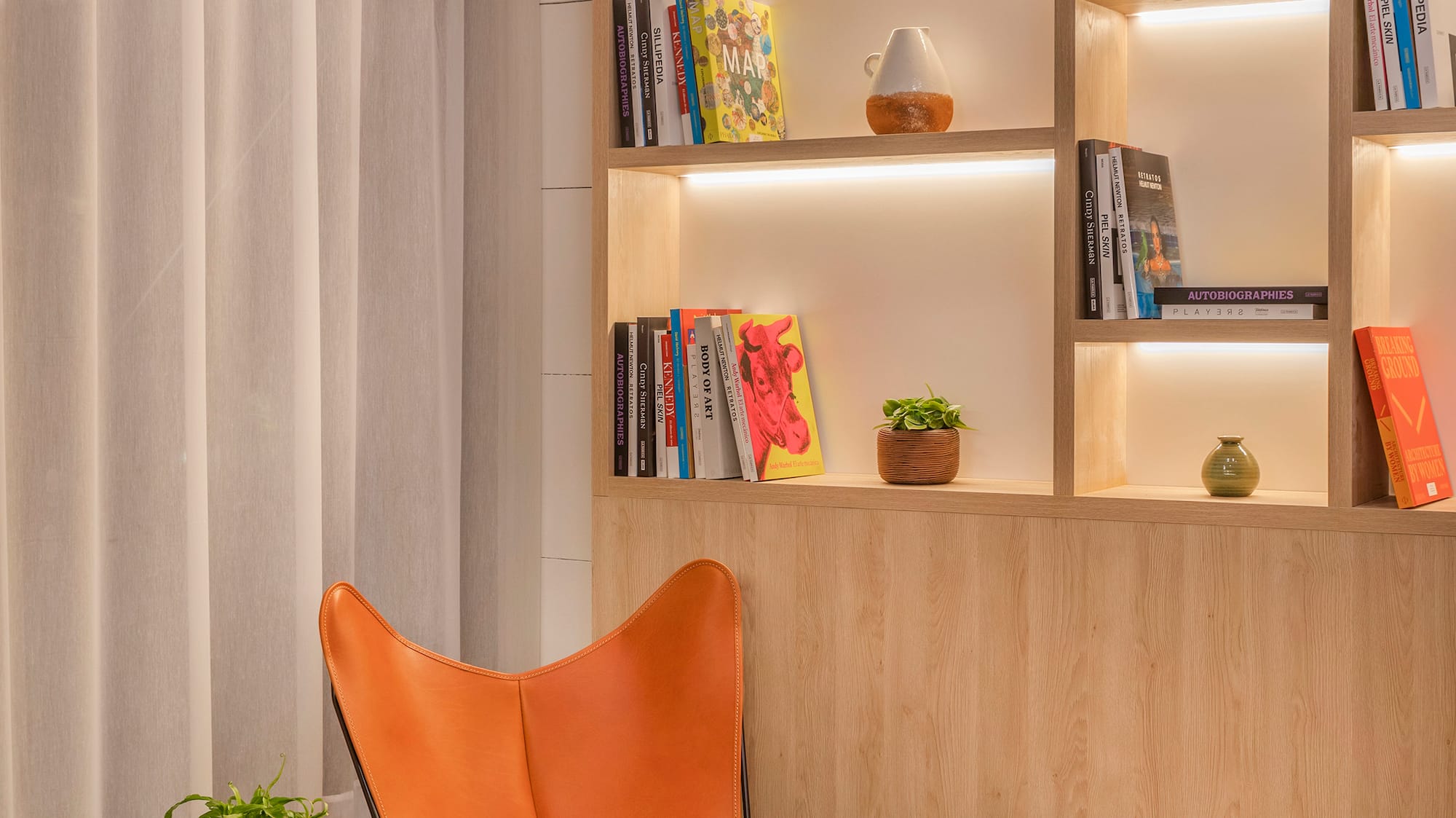 a chair and table in a room with books on shelves