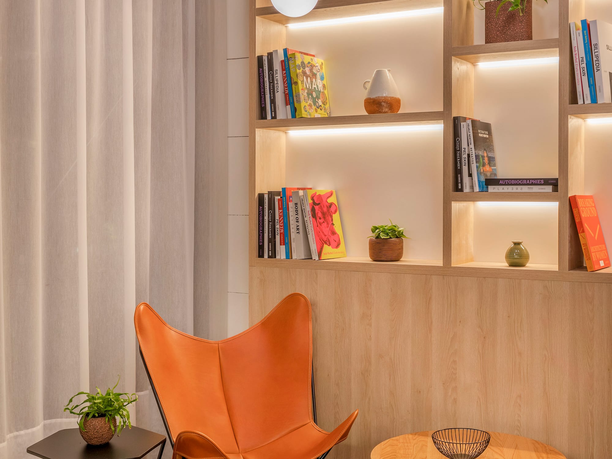 a chair and table in a room with books on shelves