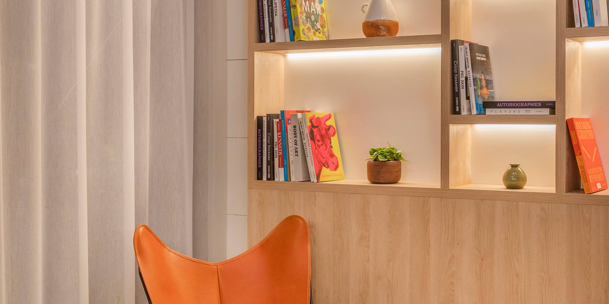 a chair and table in a room with books on shelves