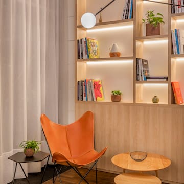 a chair and table in a room with books on shelves
