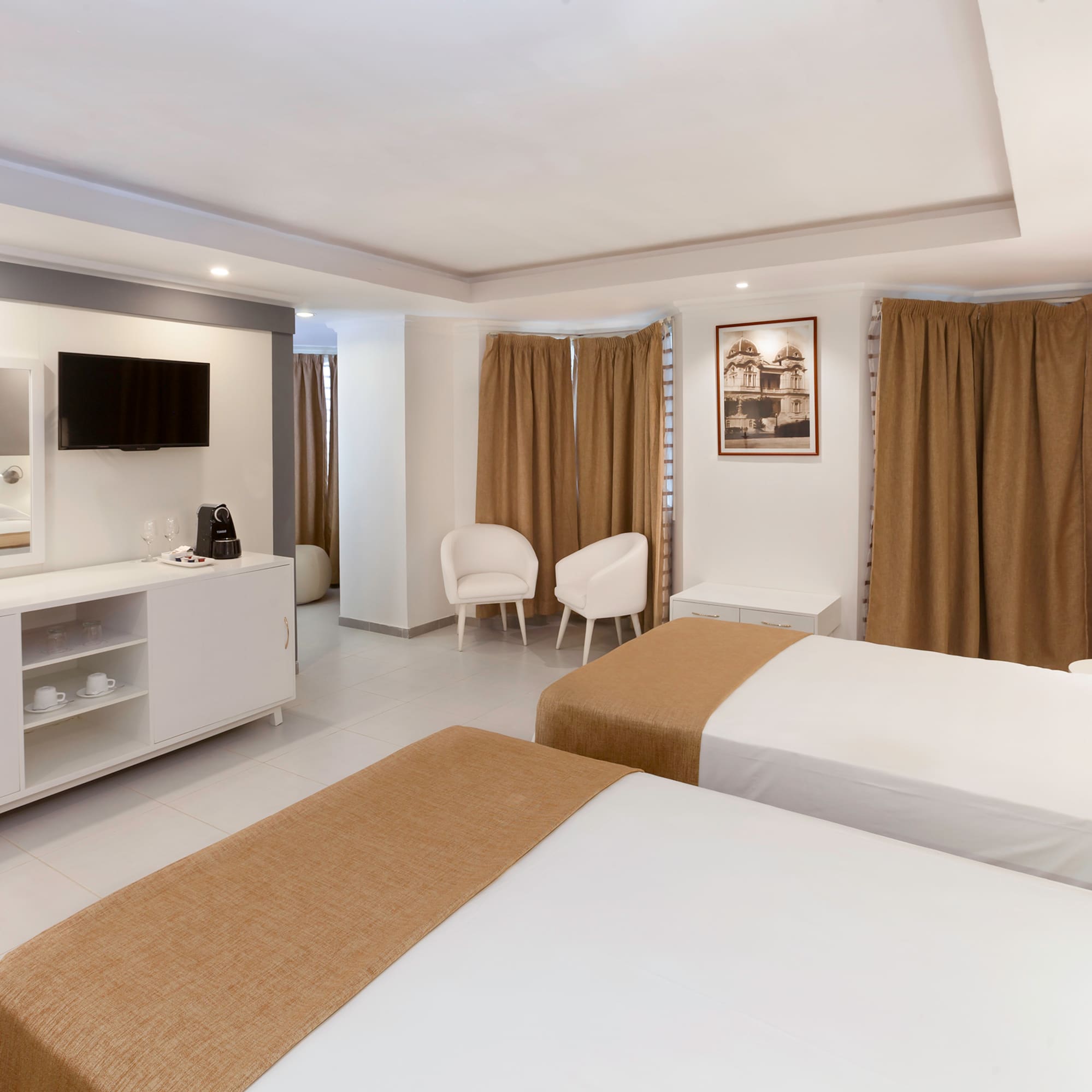 a room with two beds and a tv