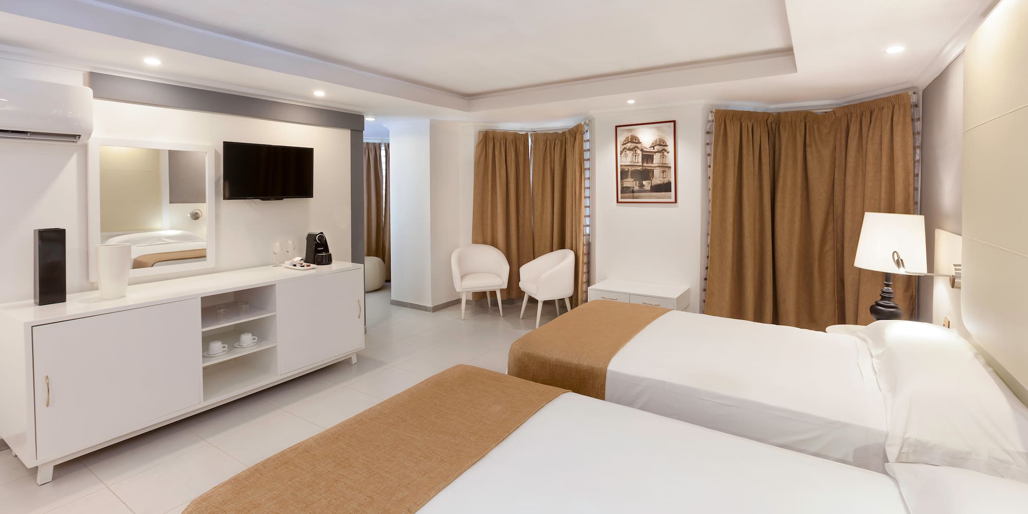 a room with two beds and a tv