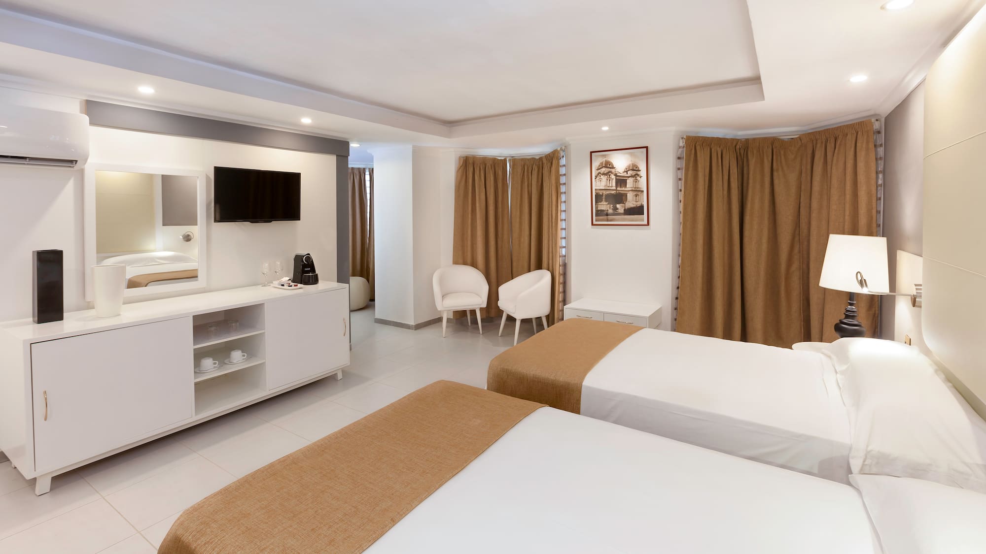 a room with two beds and a tv