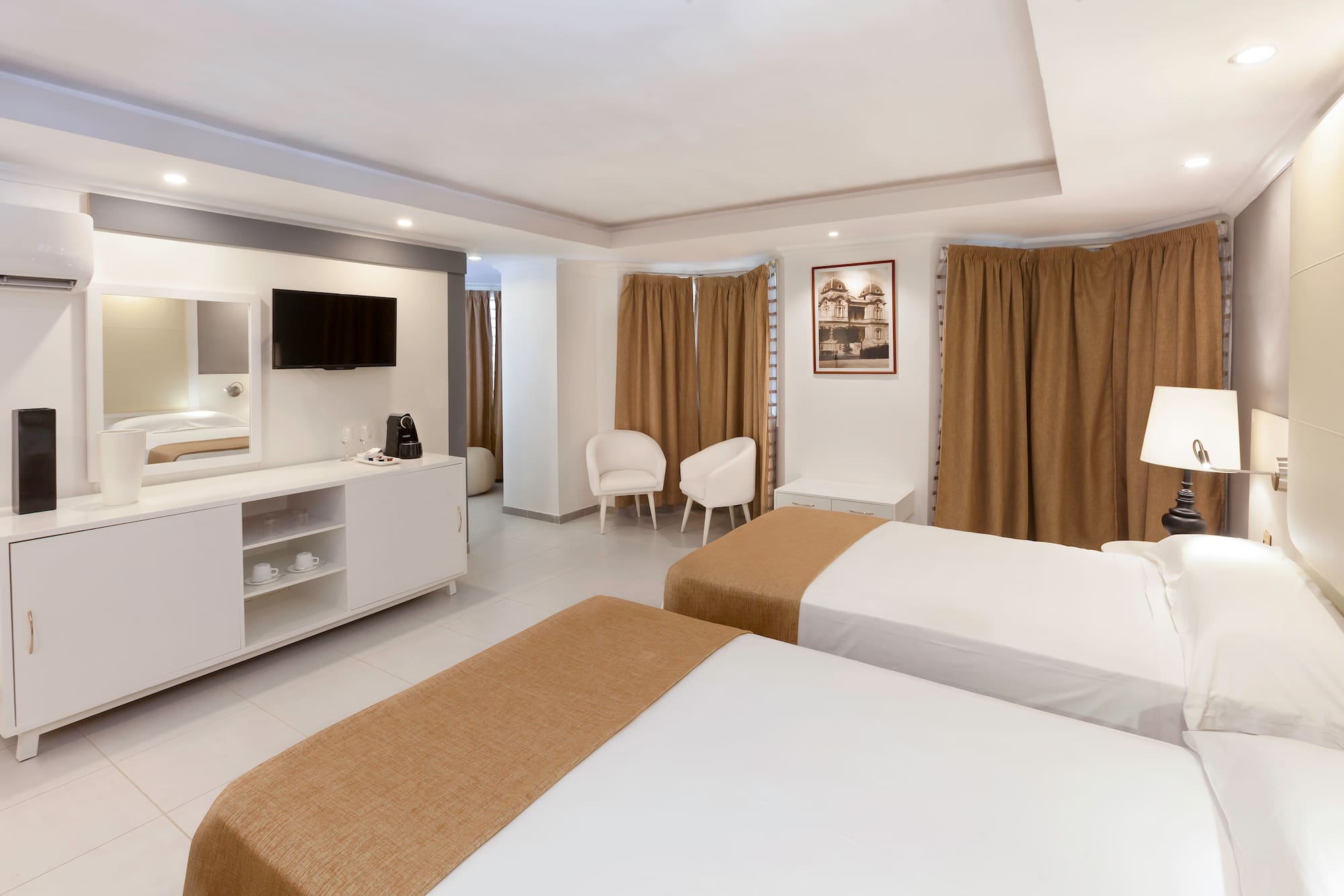 a room with two beds and a tv