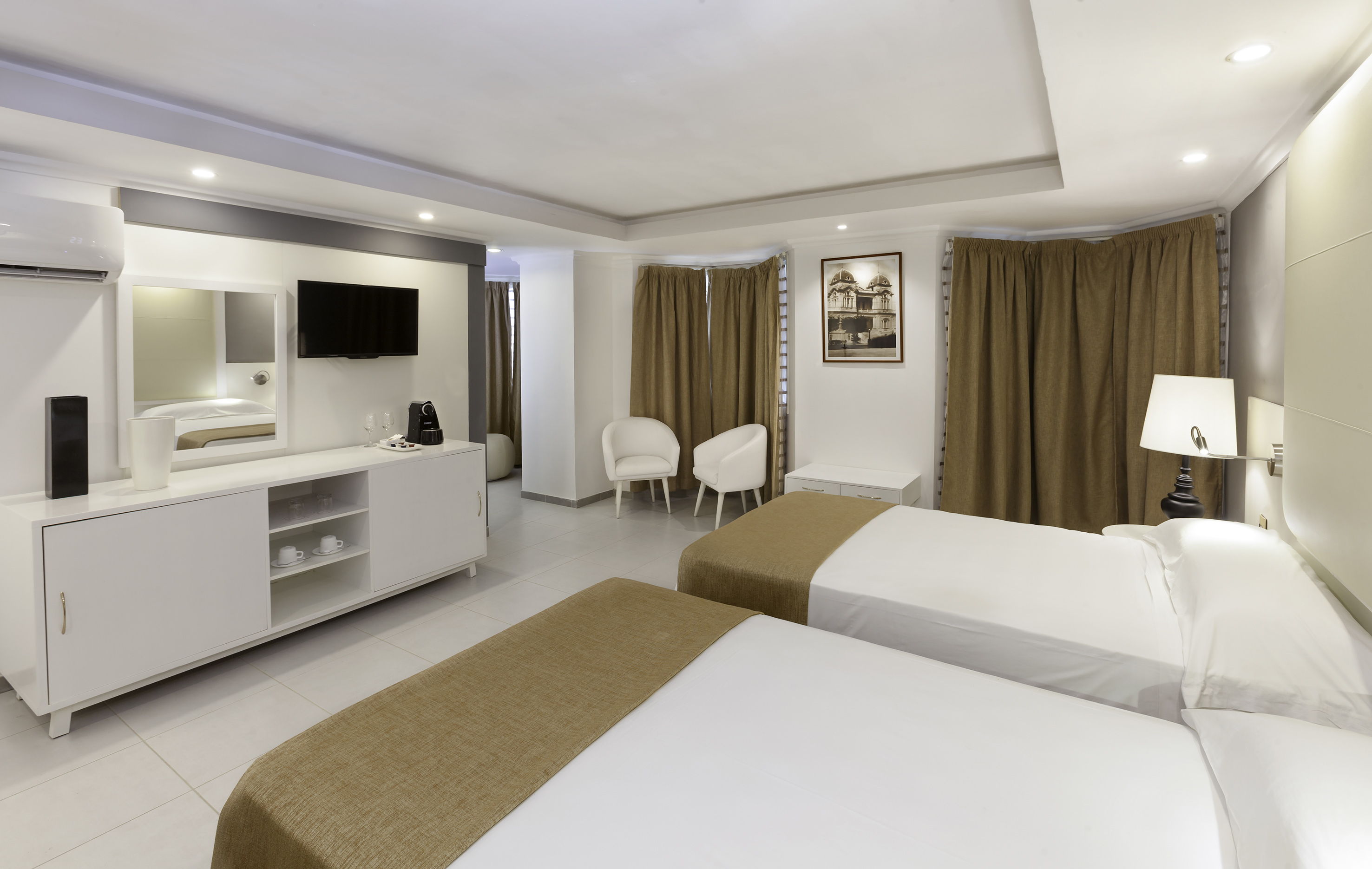 a room with two beds and a tv