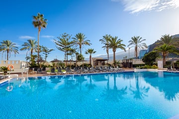 a pool with chairs and trees