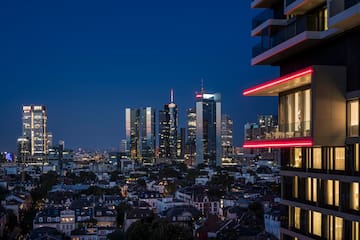 a city skyline with a balcony and a red strip of lights