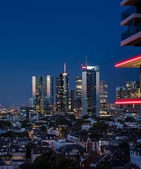 a city skyline with a balcony and a red strip of lights