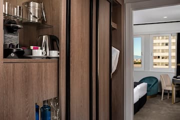 a room with a shelf and a coffee pot