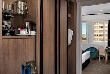 a room with a shelf and a coffee pot