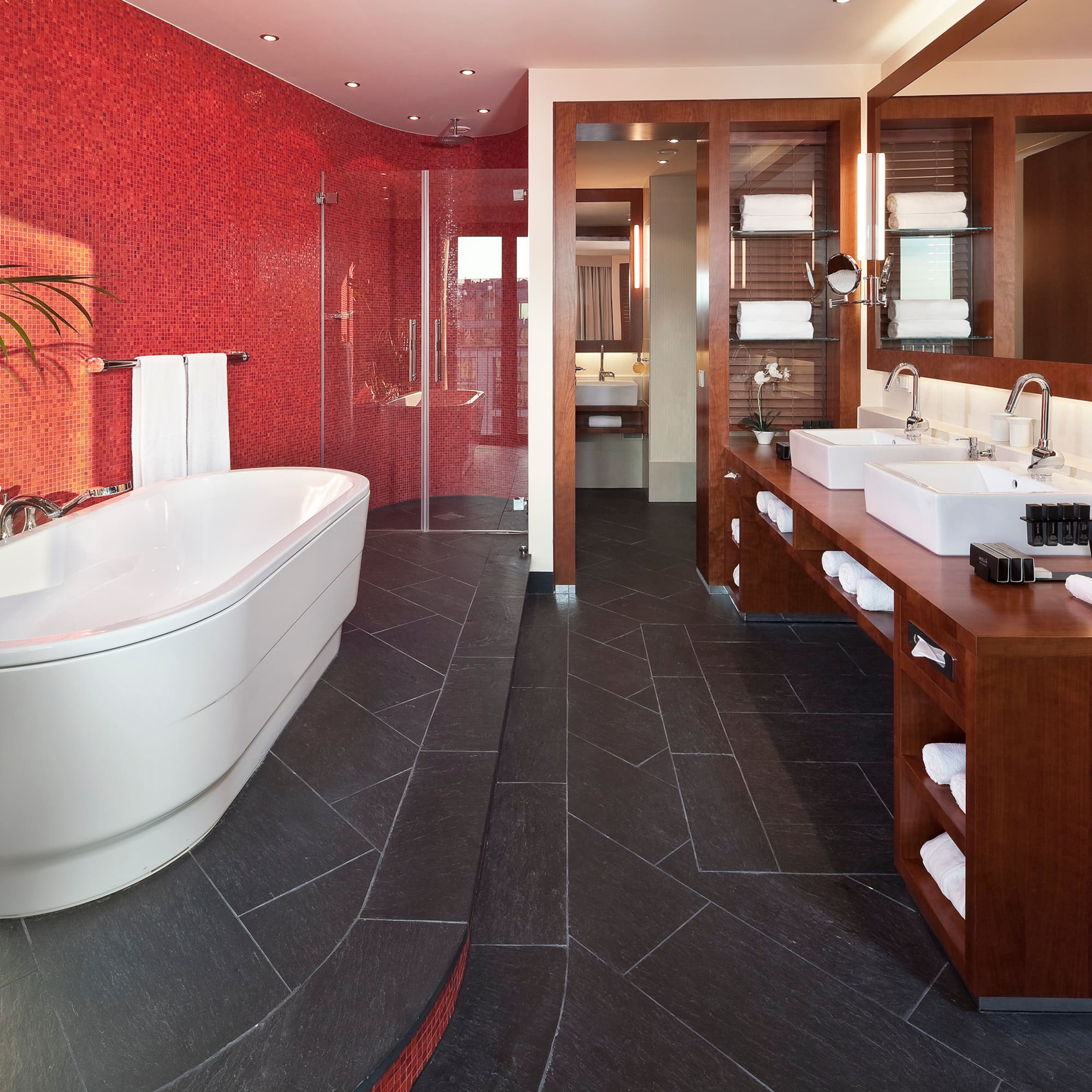 a bathroom with a large tub and sinks