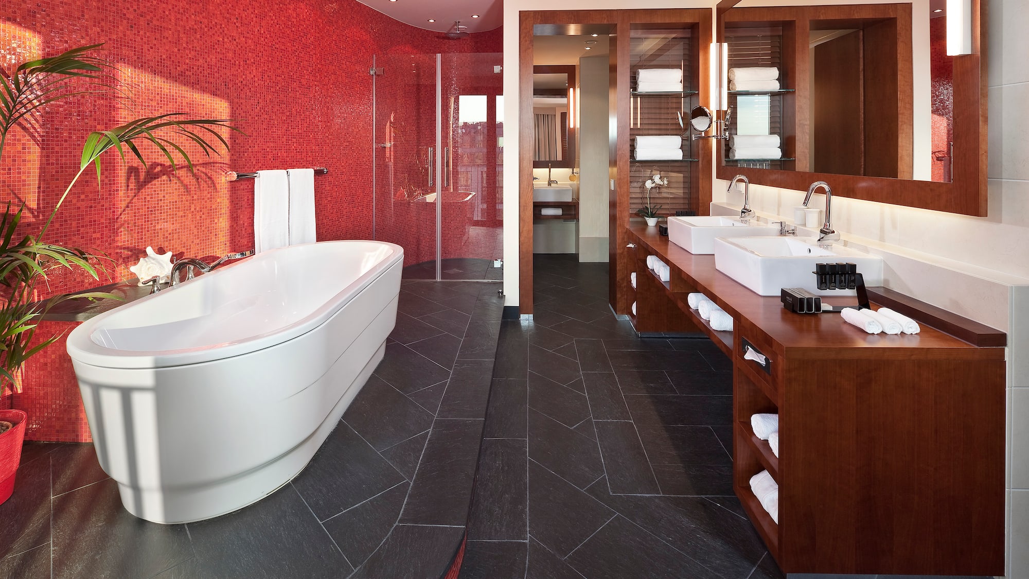 a bathroom with a large tub and sinks