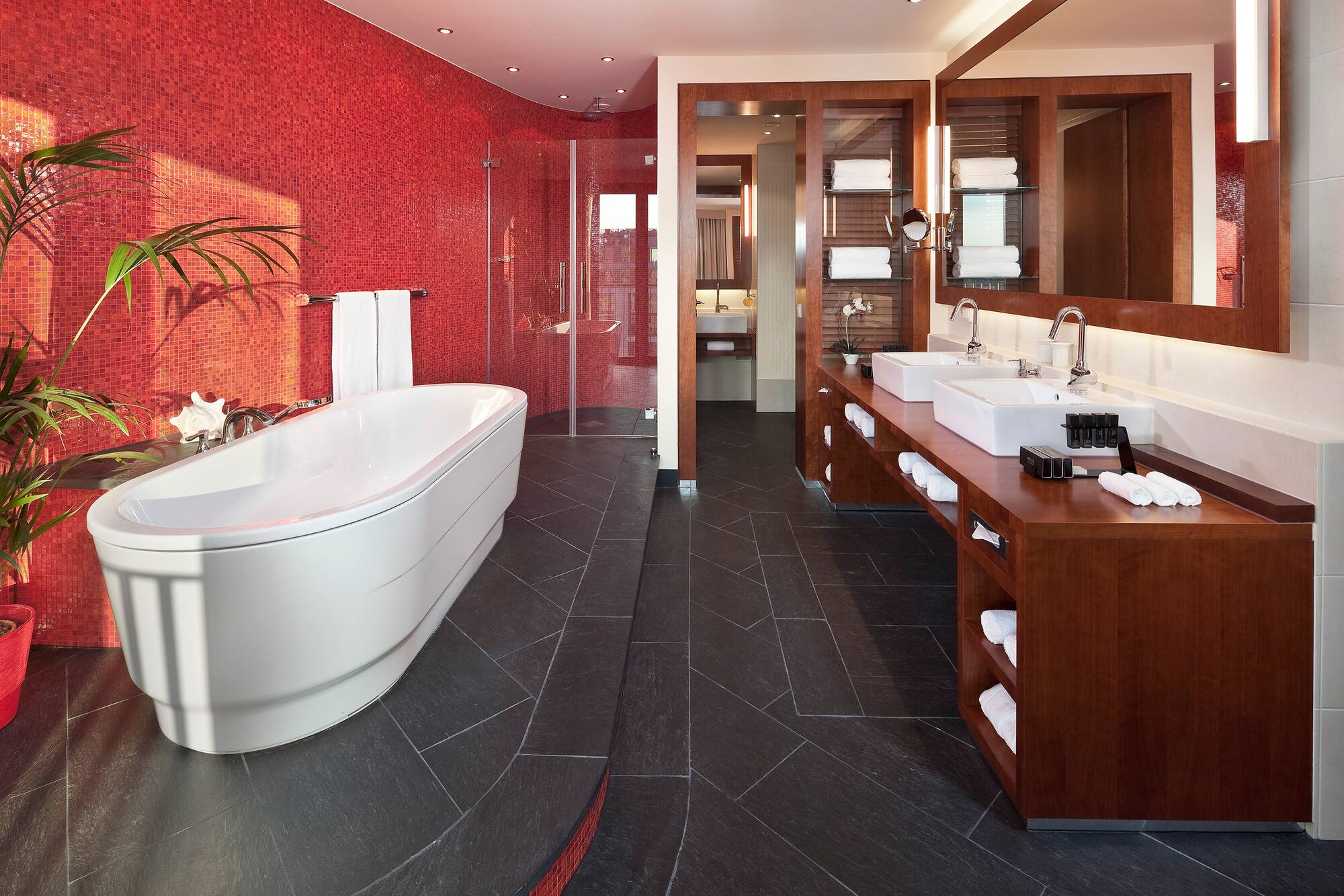 a bathroom with a large tub and sinks