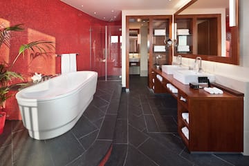 a bathroom with a large tub and sinks