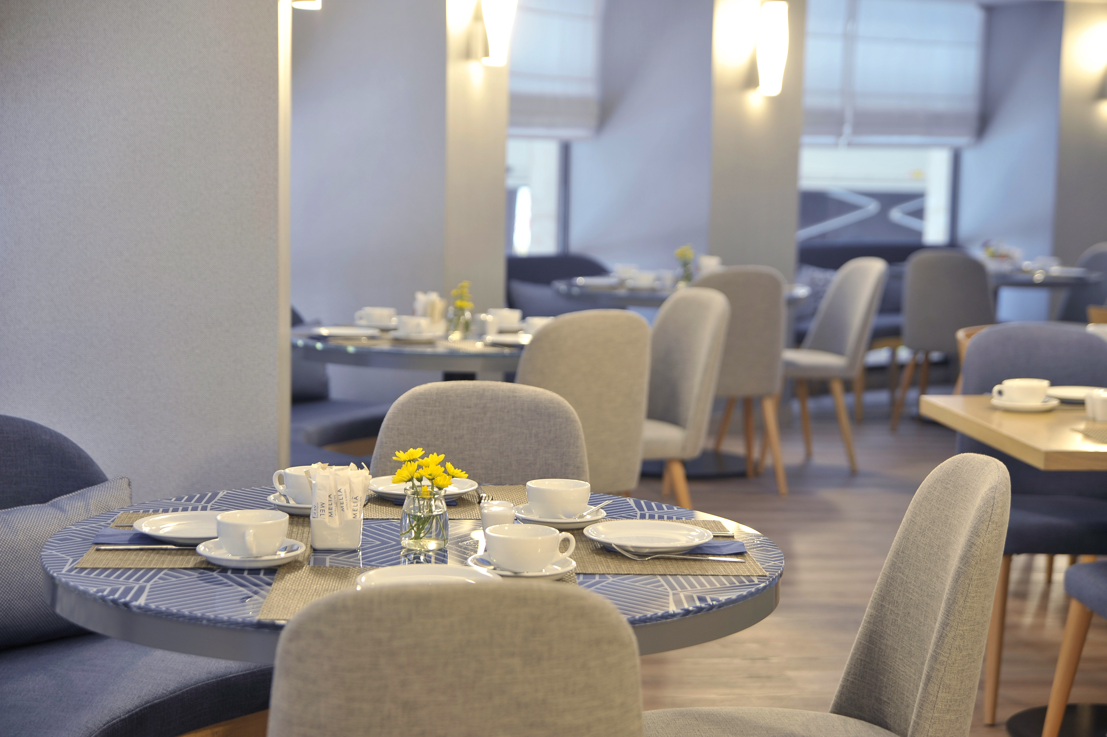 Melia Hotel dining room with blue patterned tables set for breakfast.