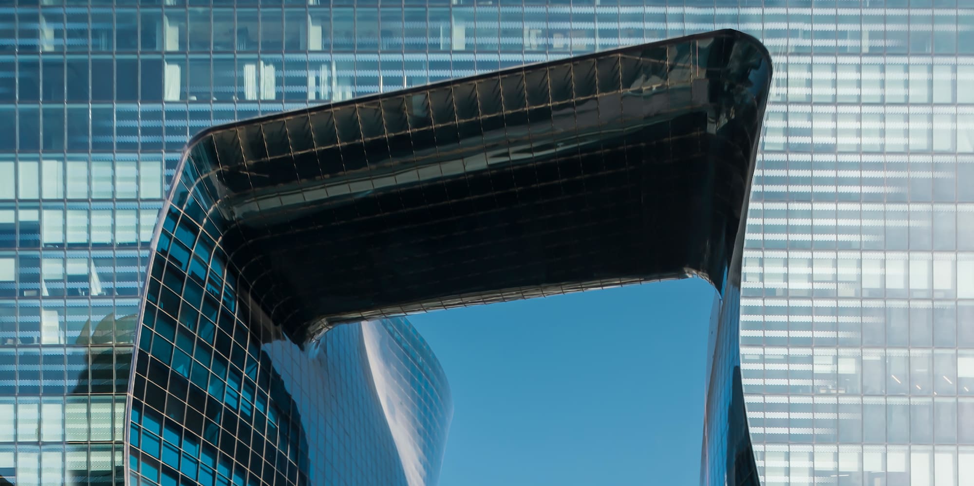a glass building with a curved roof