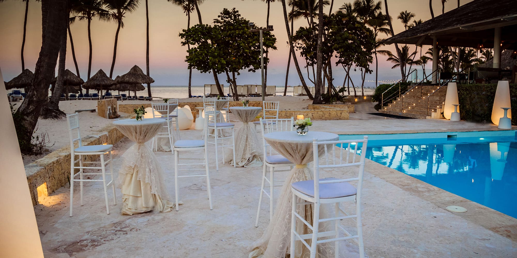 a pool with tables and chairs