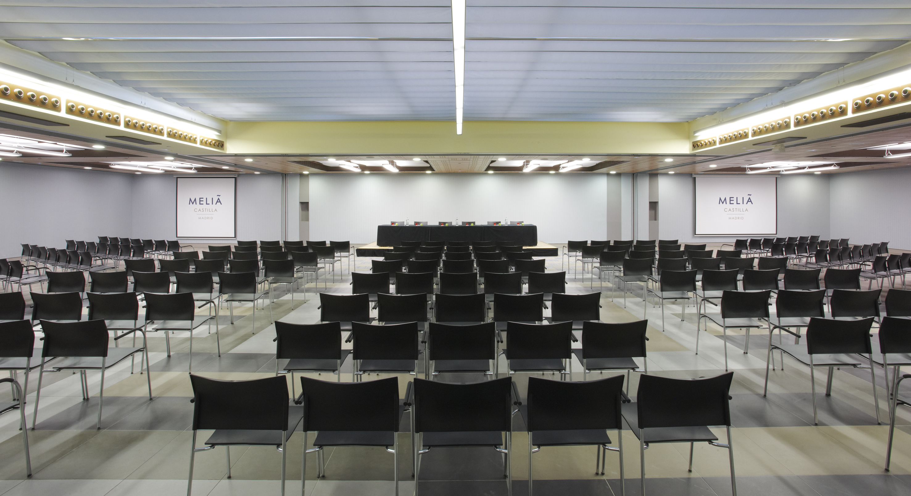 Melia Castilla Madrid conference room, chairs, stage, screens.