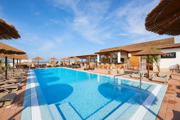a pool with umbrellas and chairs