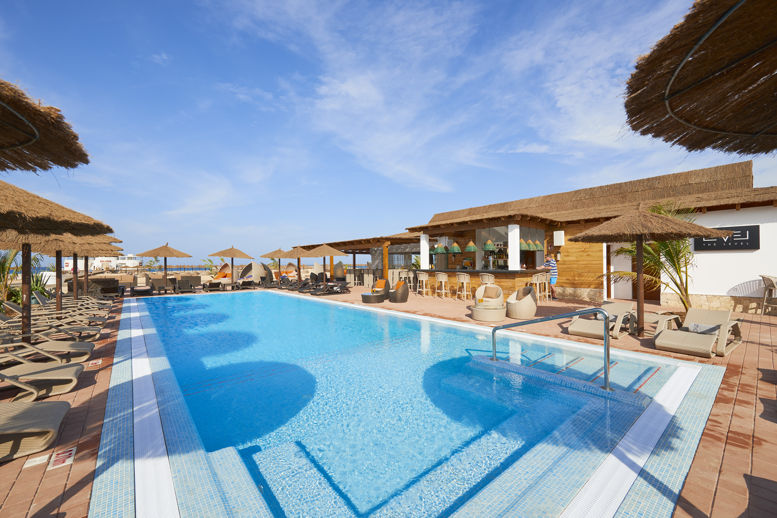 a pool with umbrellas and chairs