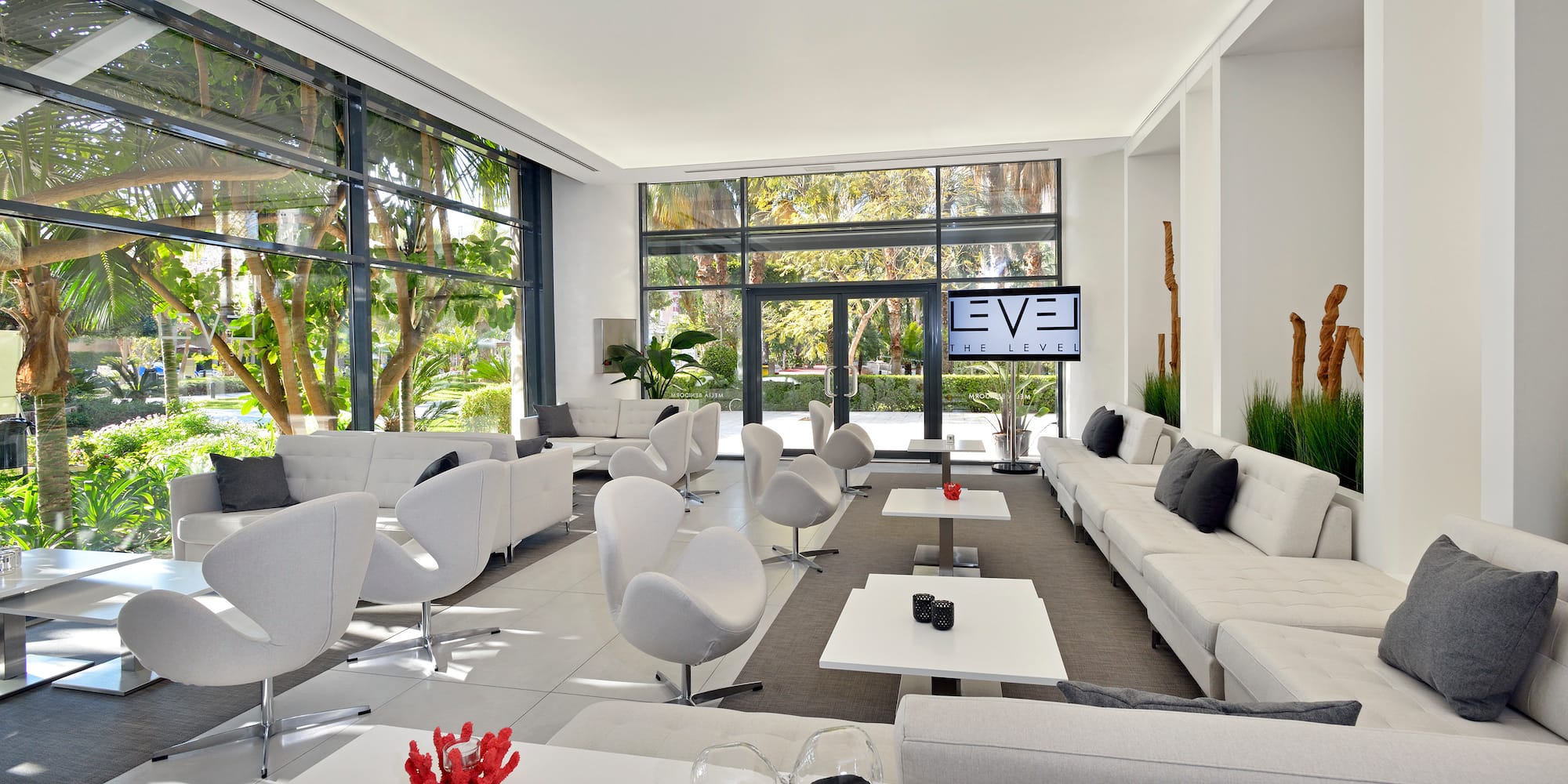 a room with white furniture and a large window