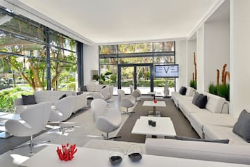 a room with white furniture and a large window