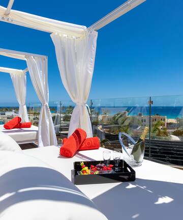 a white canopy with white curtains and towels on it