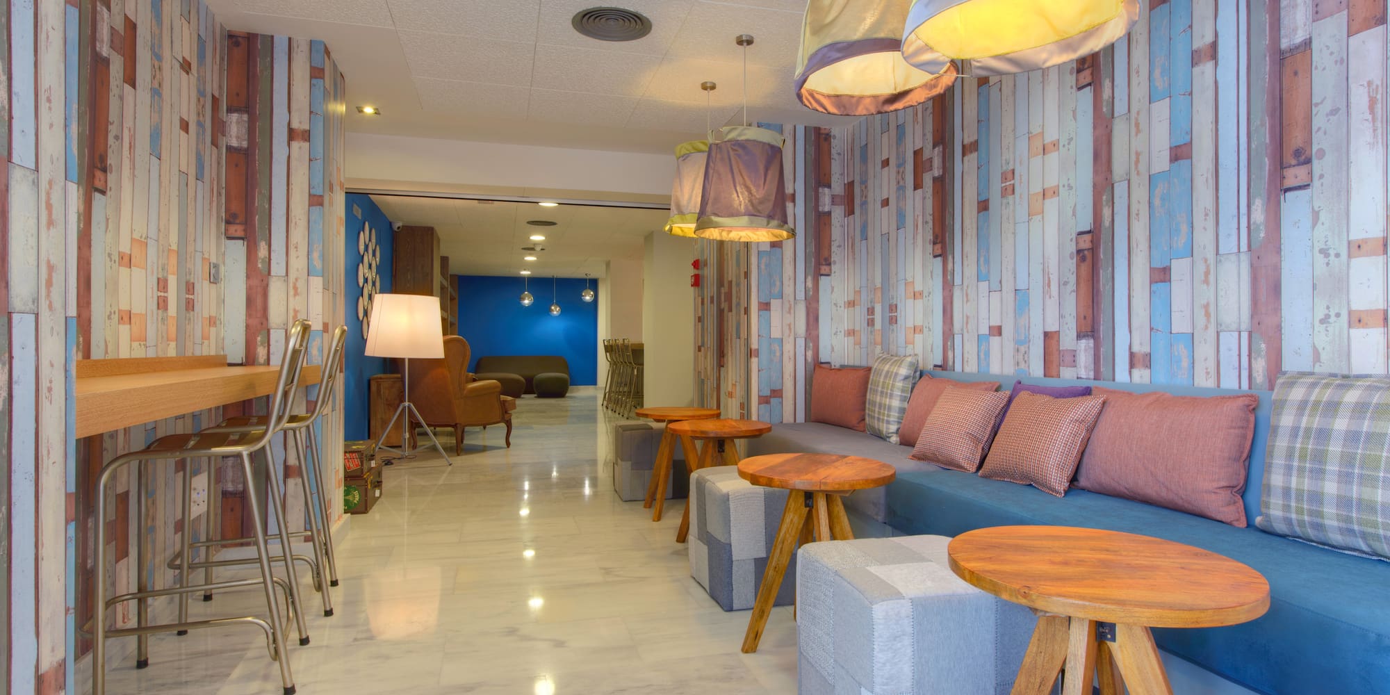 a room with a couch and tables and chairs