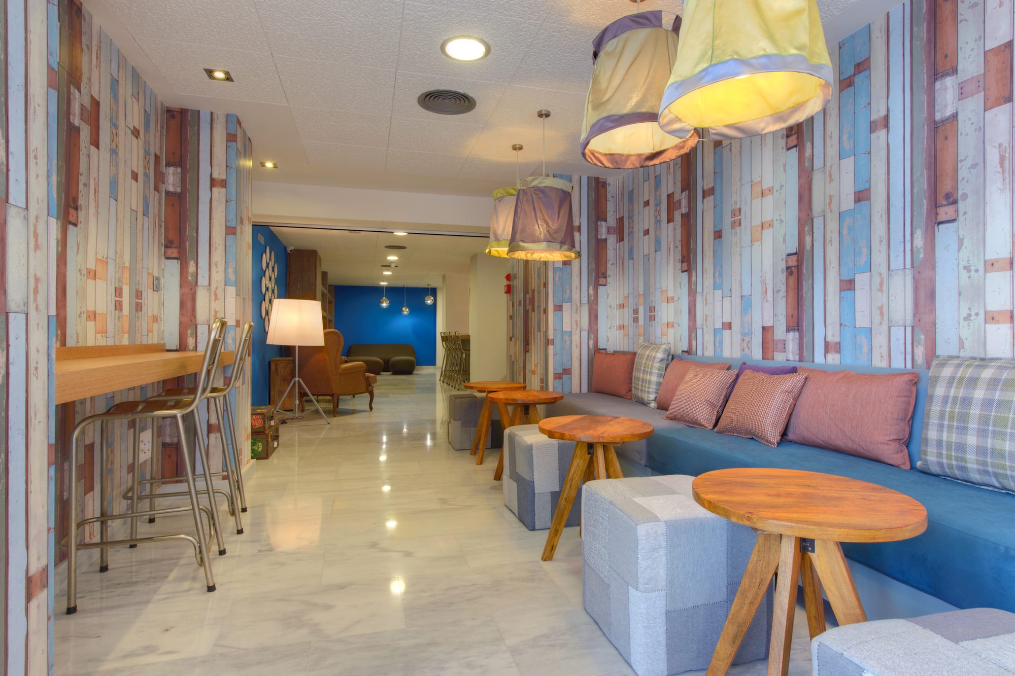 a room with a couch and tables and chairs