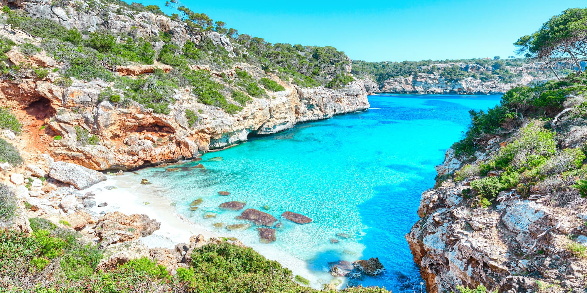 a blue water and rocks