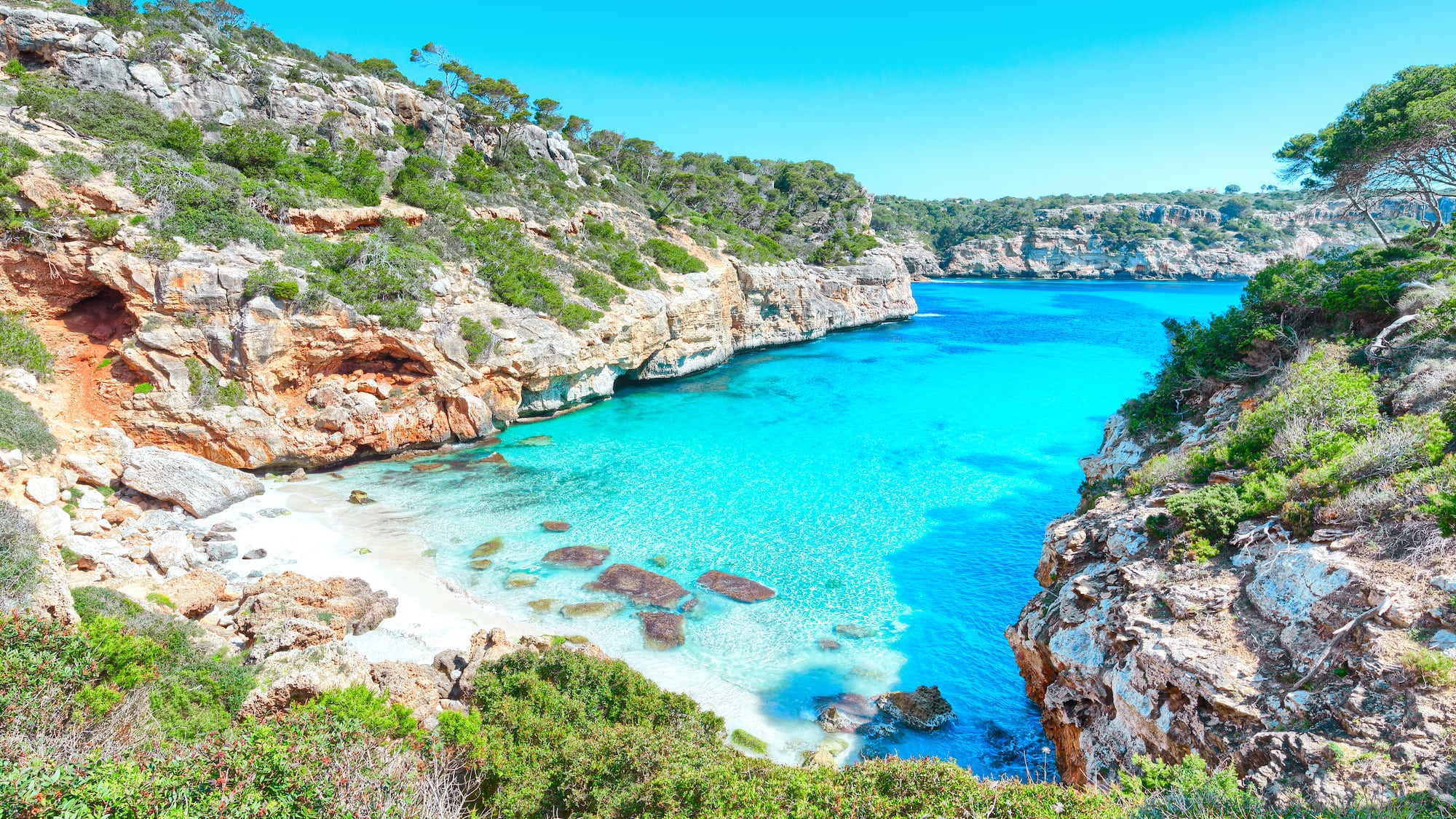 a blue water and rocks