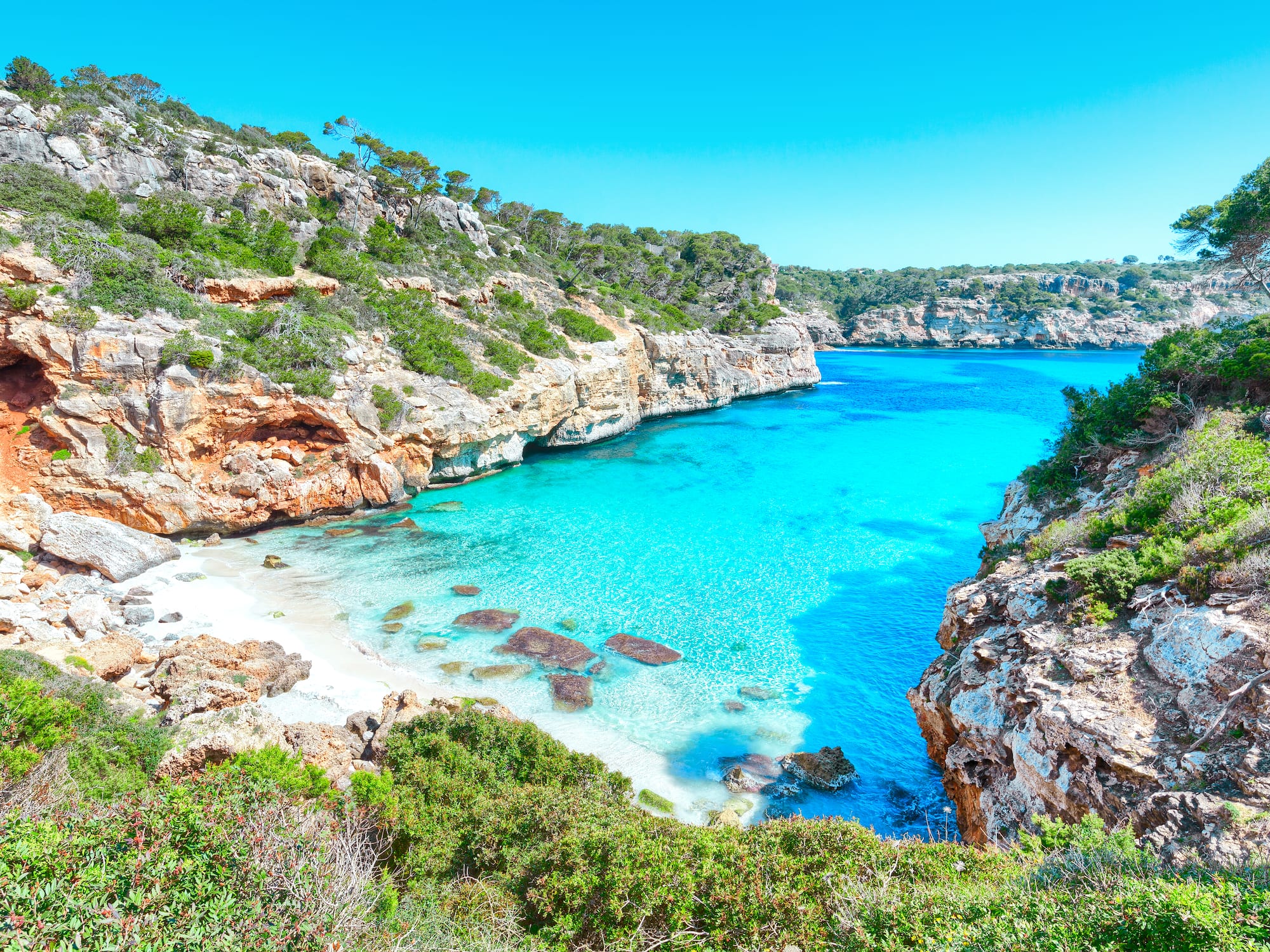 a blue water and rocks