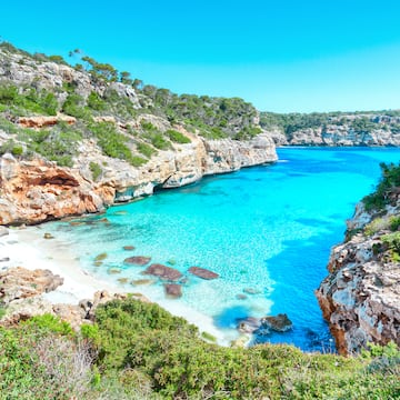 a blue water and rocks
