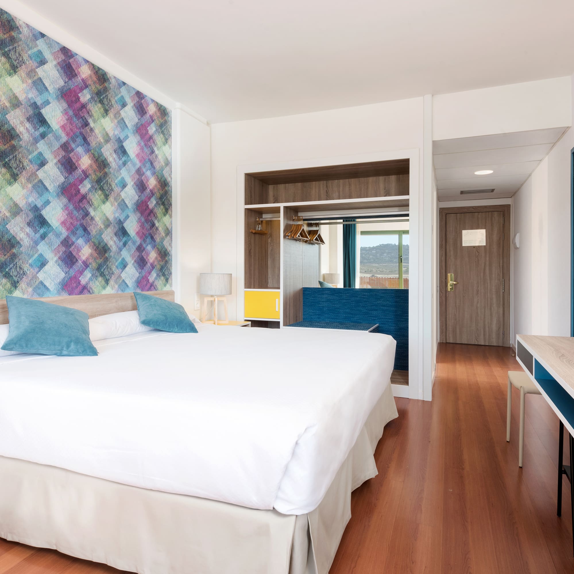 a room with a bed and a desk