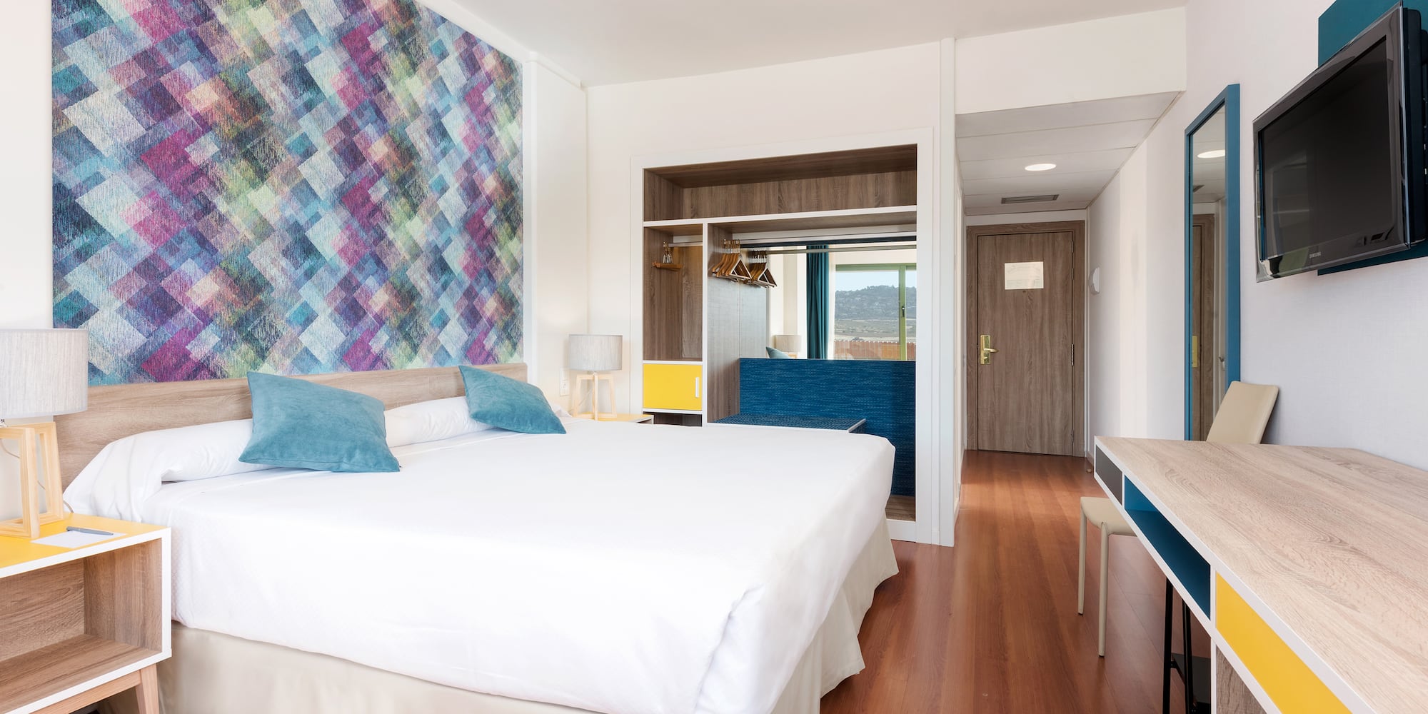 a room with a bed and a desk