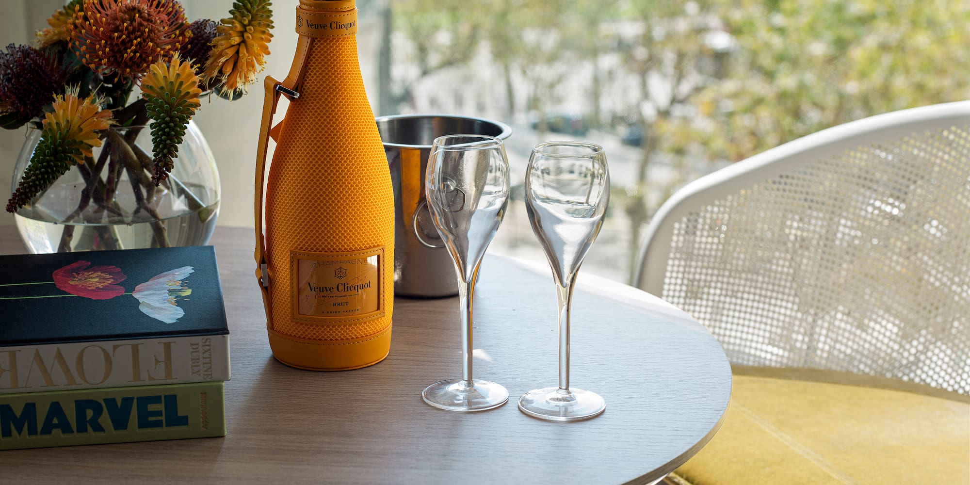 a table with wine glasses and a bottle on it