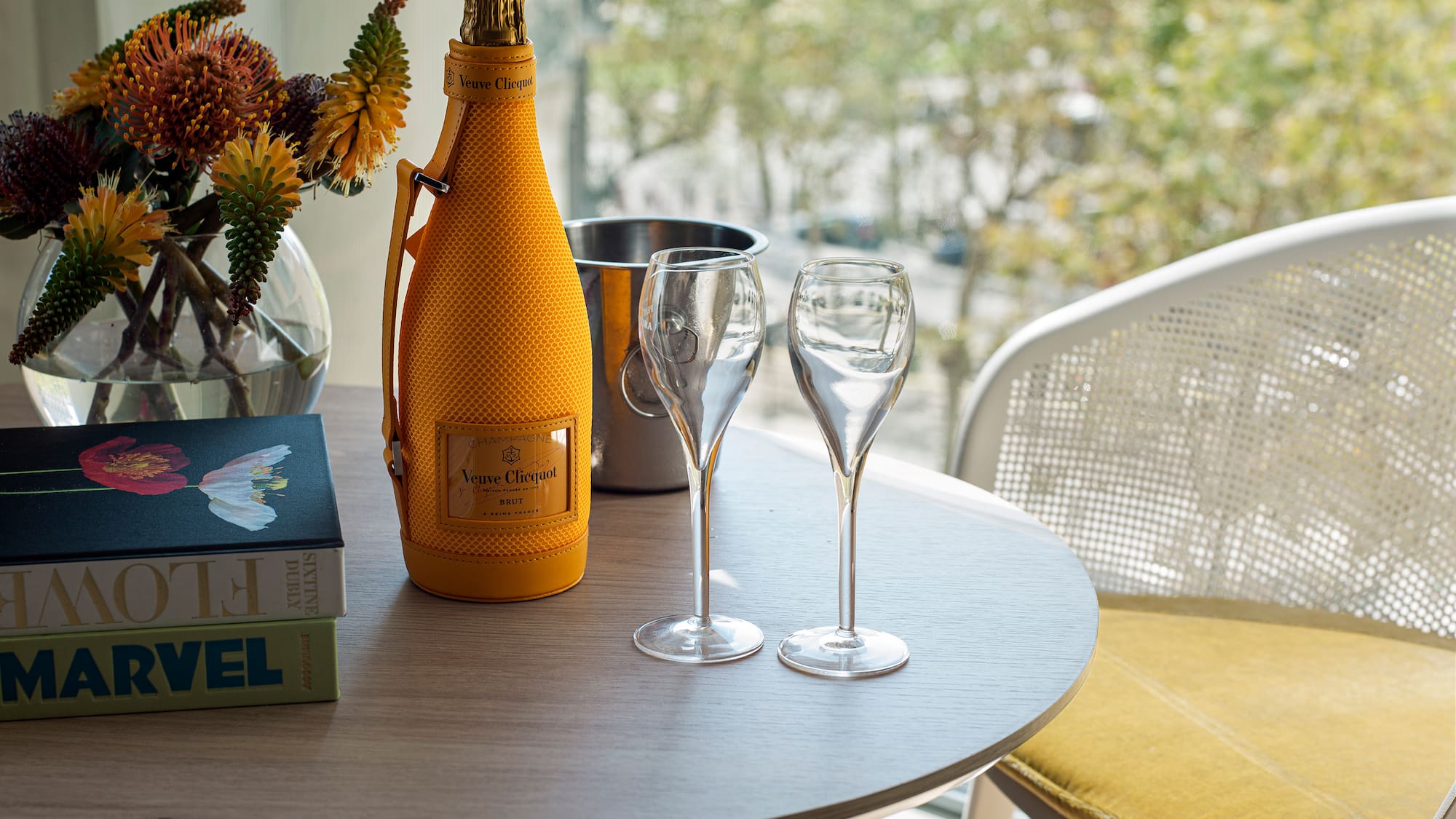 a table with wine glasses and a bottle on it