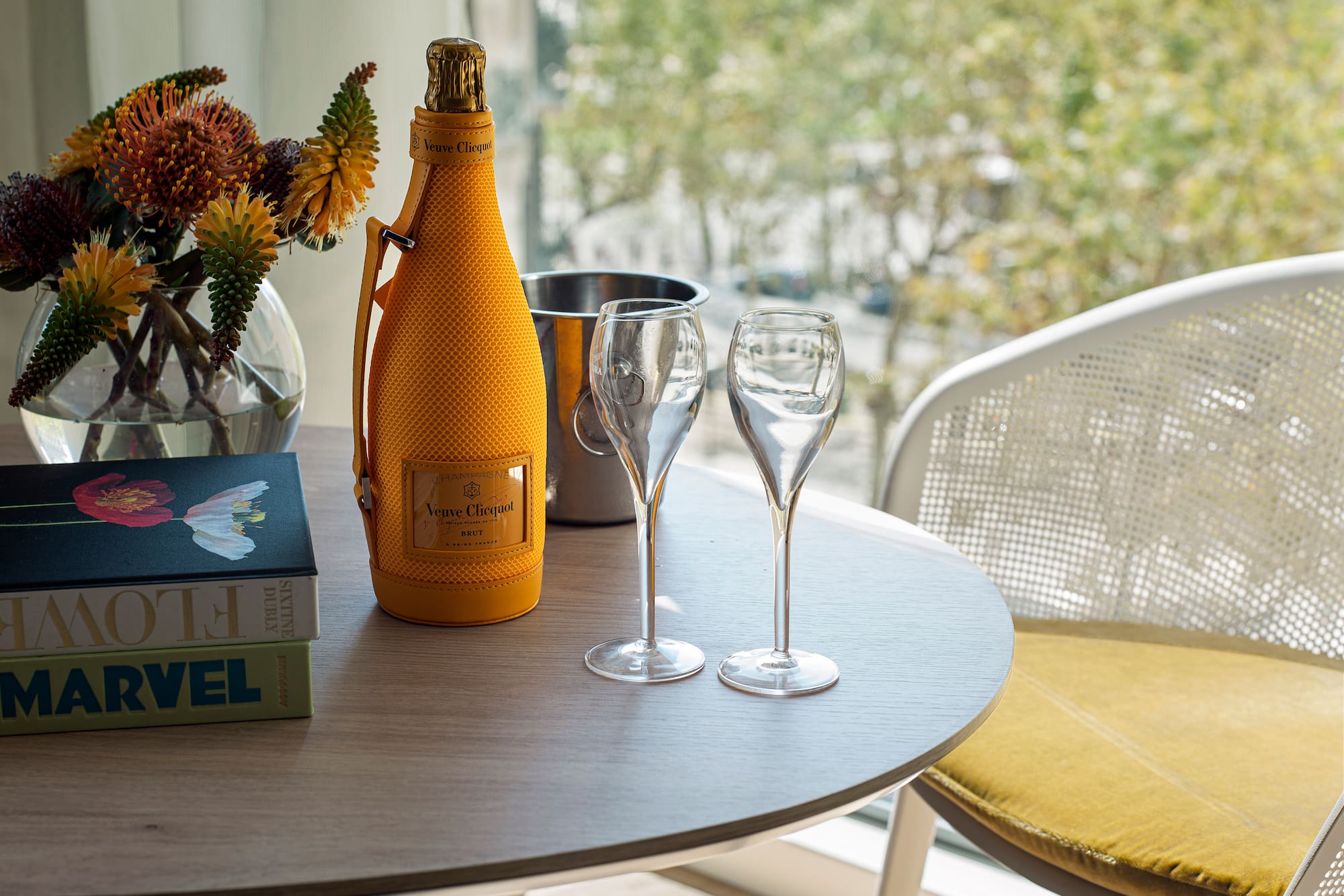 a table with wine glasses and a bottle on it