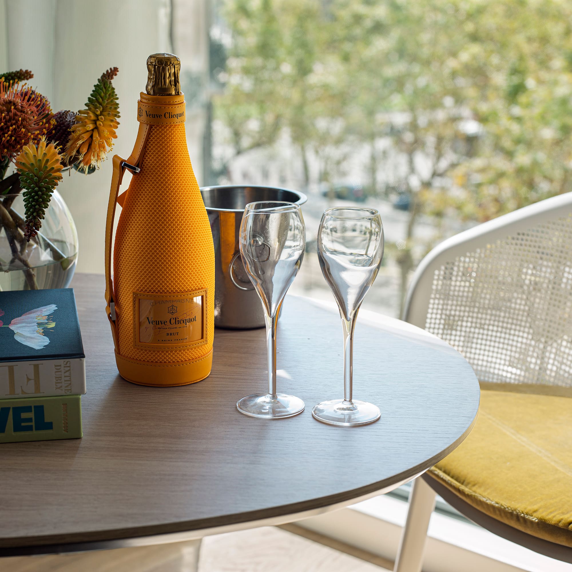 a table with wine glasses and a bottle on it