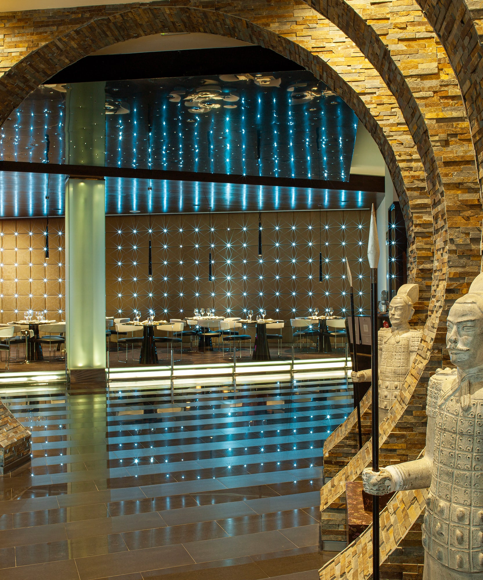 a stone archway with a couple of statues in it