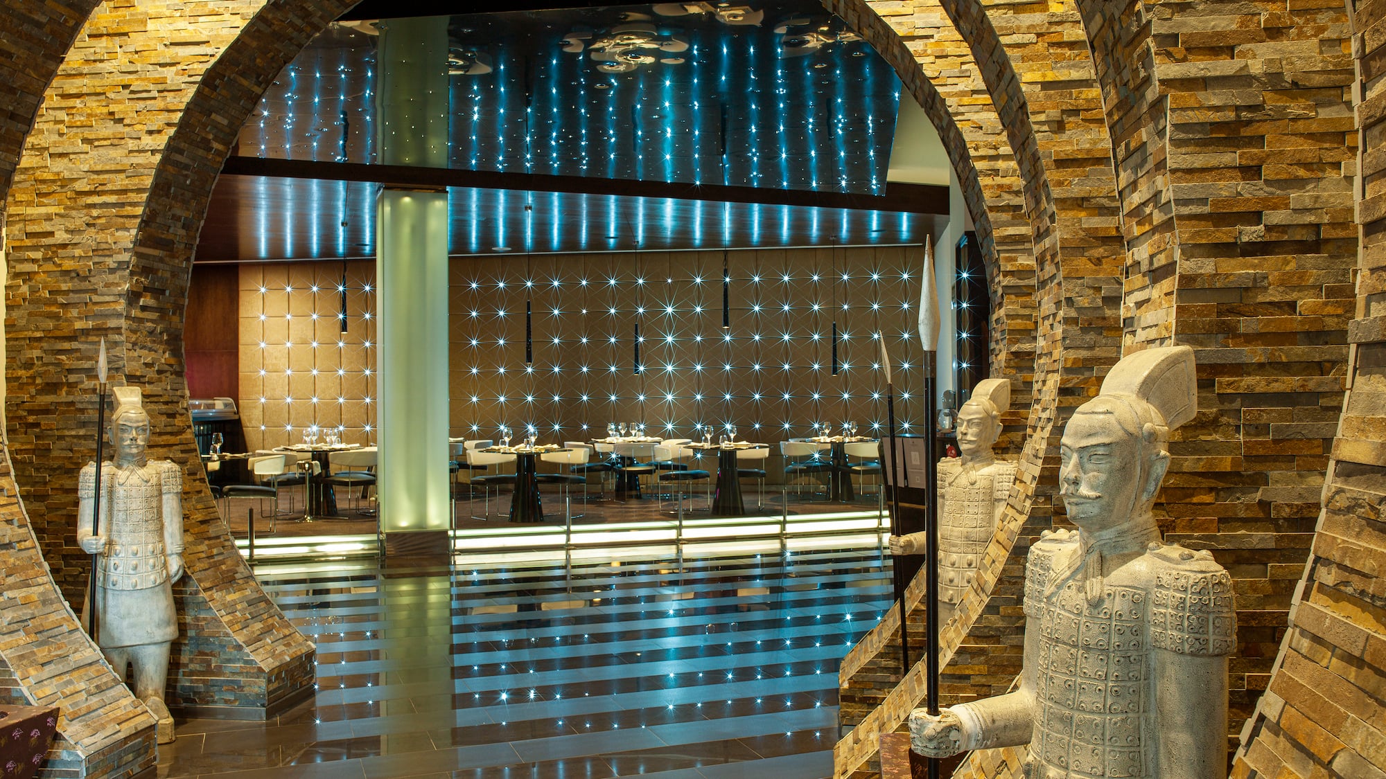 a stone archway with a couple of statues in it