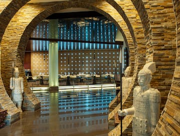 a stone archway with a couple of statues in it