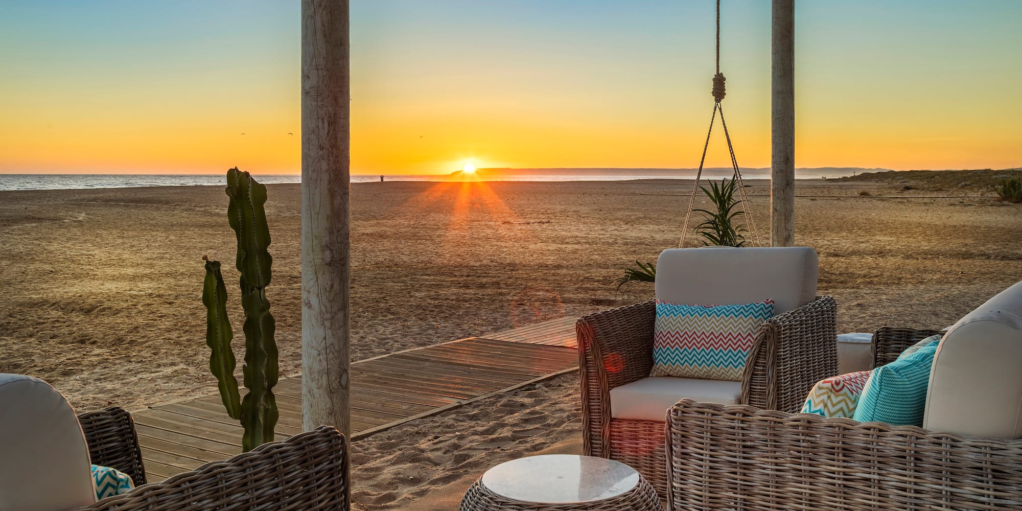 a sun setting over a beach