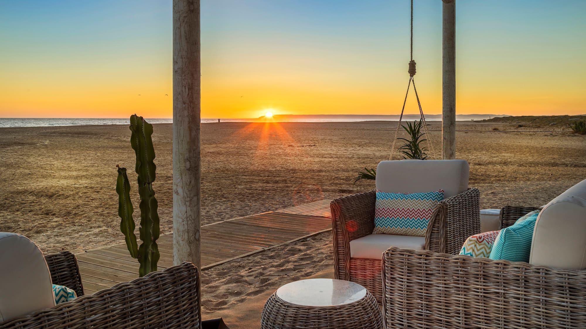 a sun setting over a beach