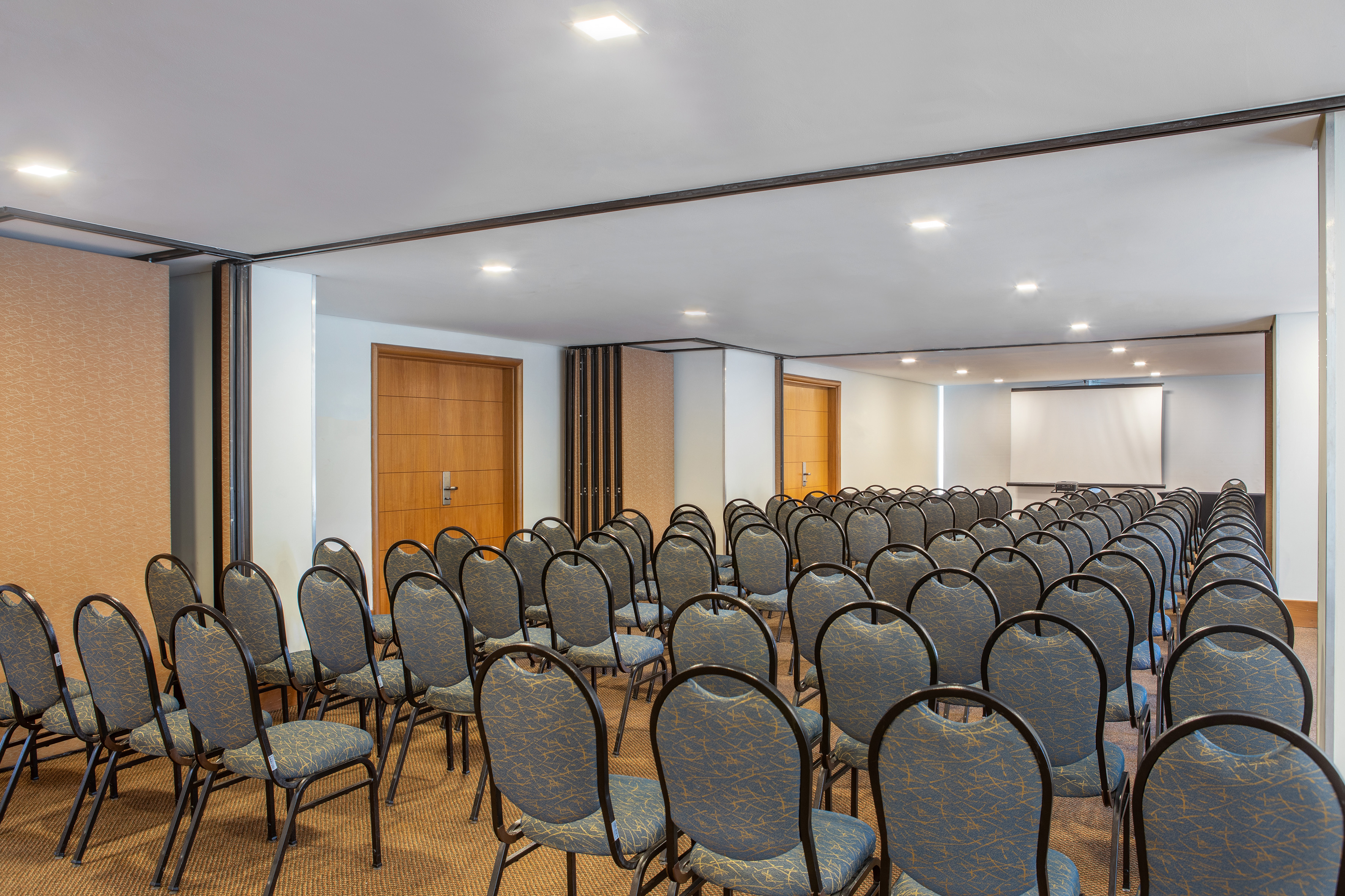 a room with chairs and a projector screen
