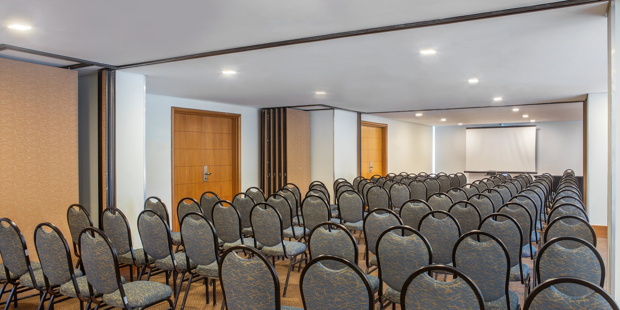 a room with chairs and a projector screen