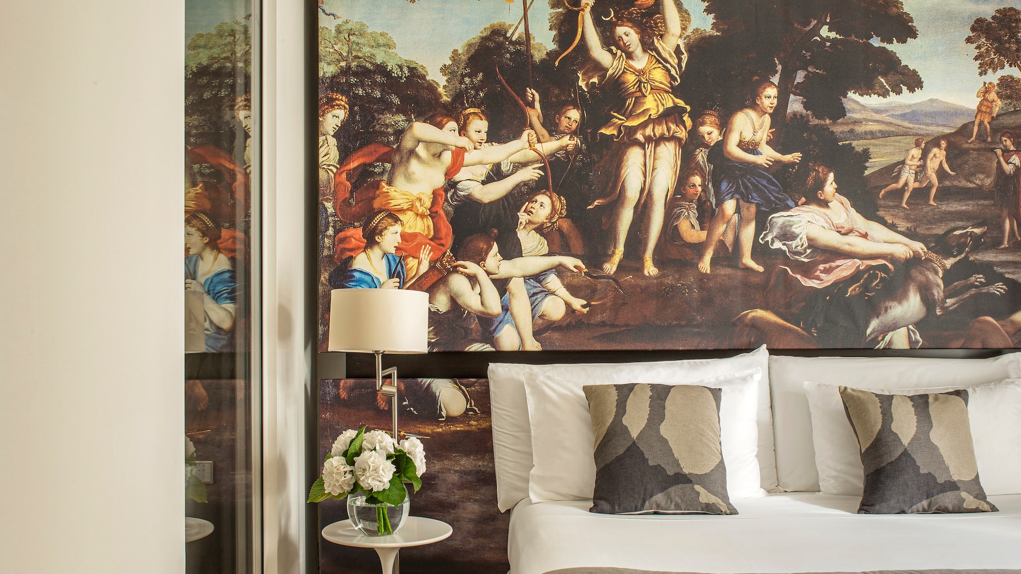 a bed with a large painting on the wall