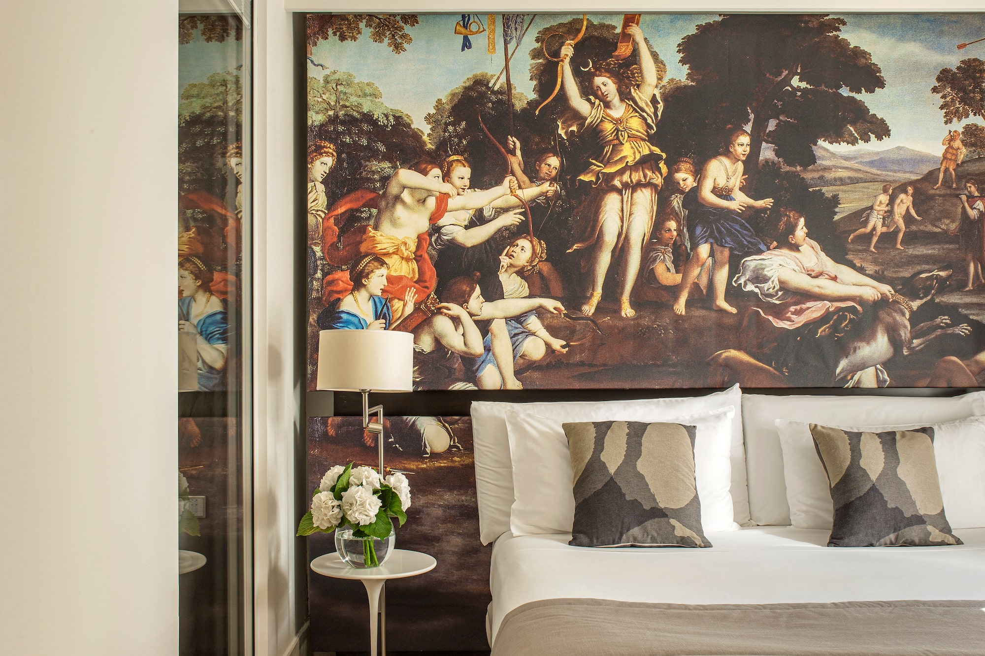 a bed with a large painting on the wall